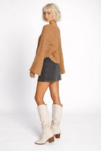 Side profile of the model wearing Hollowed Detail Wide Sleeve Loose Pullover Sweater