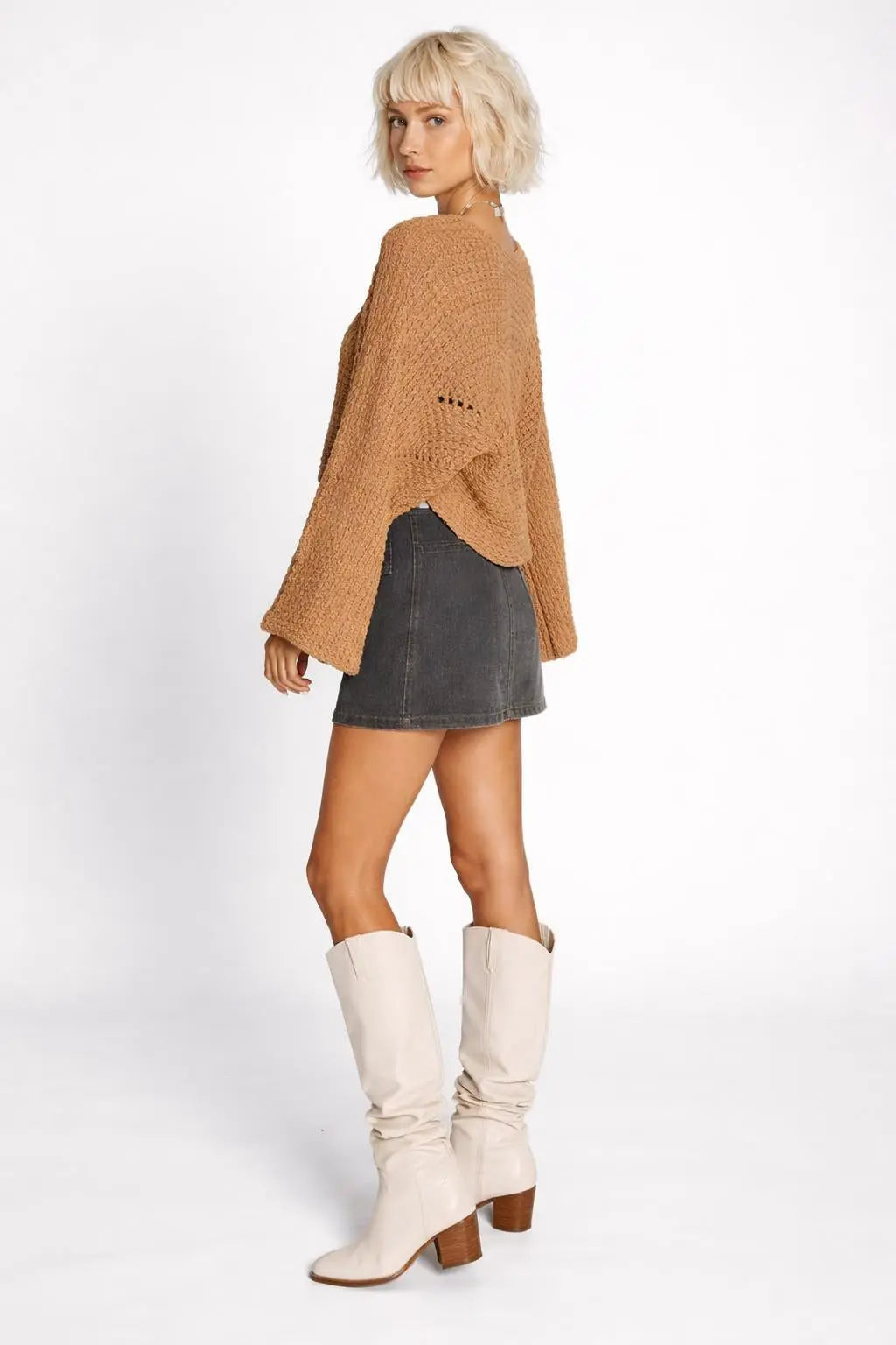 Side profile of the model wearing Hollowed Detail Wide Sleeve Loose Pullover Sweater