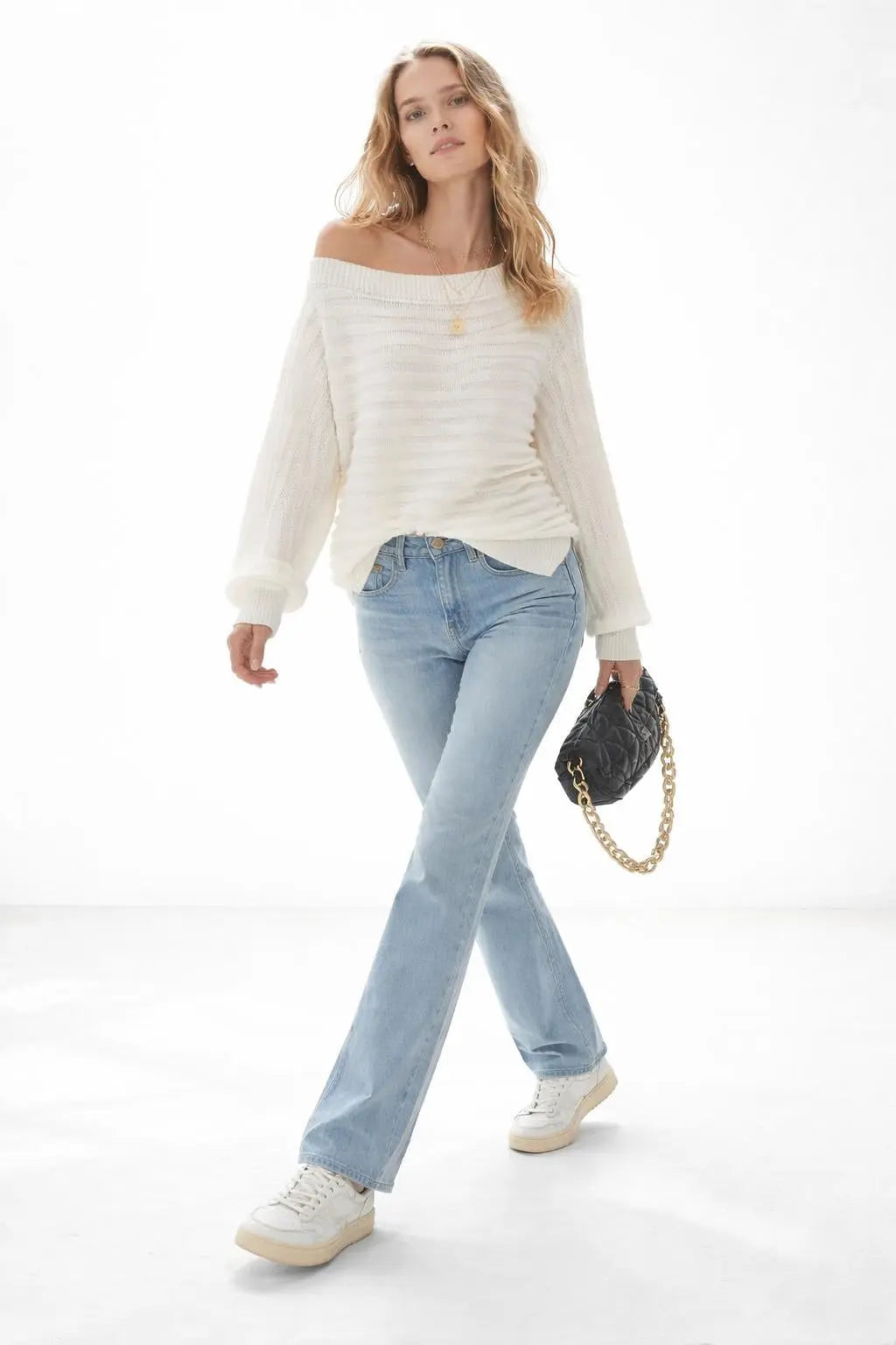 Model walking while wearing One Shoulder Ribbed Knit Sweater