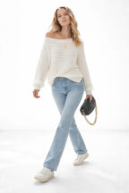 Model walking while wearing One Shoulder Ribbed Knit Sweater
