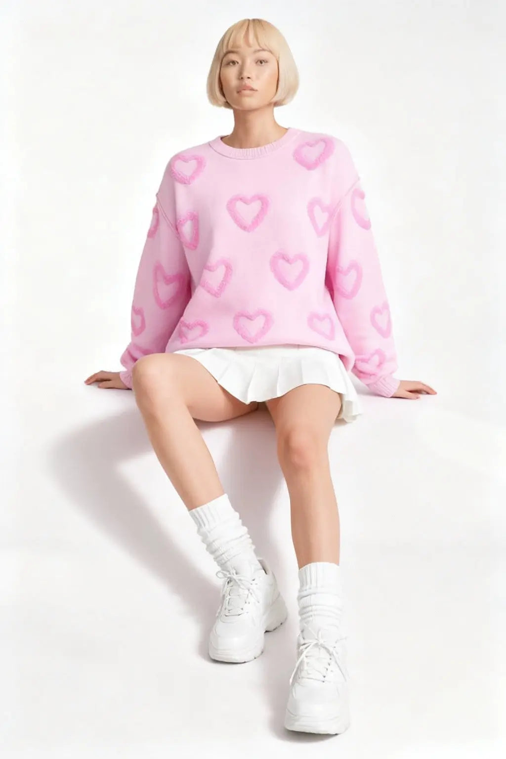 Model sitting while wearing Heart Shape Bubble Sleeve Baggy Sweater